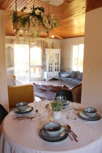 a table with plates and wine glasses on it at Le Lodge BelAir in Le Tampon +21 photos