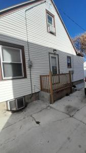 a white house with a fence in front of it at GA home in Milwaukee