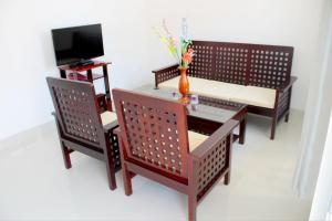 a table and two chairs and a tv in a room at 1001 Nights Hotel in Mui Ne