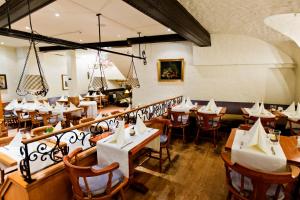 a restaurant with tables and chairs in a room at Central-Hotel Kaiserhof in Hannover