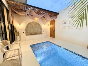 a villa with a swimming pool and a house at Canggu Villas Family Yogyakarta in Ngaglik +14 photos