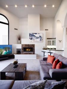 a living room with two couches and a fireplace at Luxury Mountain Estate-Pool-Spa-BBQ+Bar-Fire pit in Scottsdale