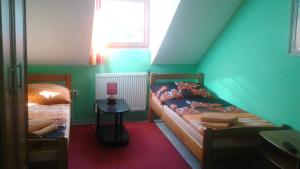 Postel nebo postele na pokoji v ubytování Guest House U Náhonu