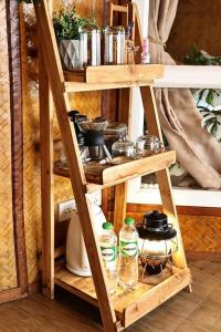 a wooden shelf with various items on it at ดานบนดินCamping in Ban Thung Phan Ha