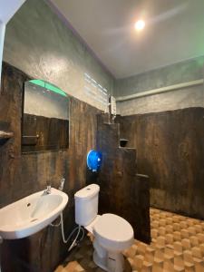 a bathroom with a white toilet and a sink at Sonya Kohlanta in Ko Lanta