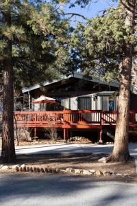 a house with a wooden deck and trees at Bearadise Cabin in Sugarloaf