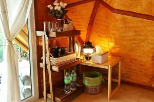 a room with a table with bottles on a shelf at ดานบนดินCamping in Ban Thung Phan Ha
