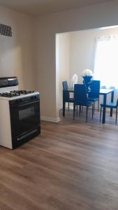a kitchen with a stove and a table with chairs at GA home in Milwaukee