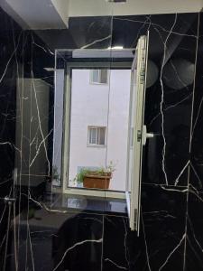 a window with a potted plant in a room at Gledys House in Krujë +11 photos