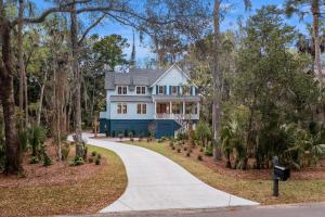 a house with a blue house and a driveway at BW3131: 3131 Baywood Drive in Seabrook Island