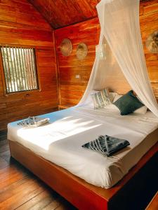 a bedroom with a bed with a mosquito net at Sonya Kohlanta in Ko Lanta