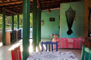 a room with green walls and a table and chairs at Casa Poesía Sayulita in Sayulita