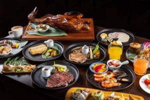 a table with a turkey and many plates of food at Butterfly Valley Resort by Cosmos Oasis in Ruisui +53 photos