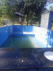 a swimming pool with a fence around it at Glass House Yelagiri in Yelagiri