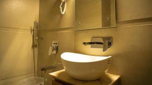 a bathroom with a white sink and a shower at Hotel Rs Vista - Agra in Agra