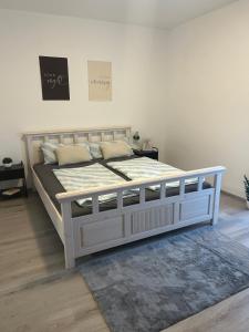 a white bed in a bedroom with a white wall at MelsHome Entire apartment to feel good in Geislingen an der Steige