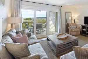 a living room with a couch and a table at PW13105: 13105 Pelican Watch in Seabrook Island