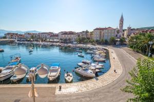 a group of boats in a harbor in a city at Hotel Osam - Adults Only in Supetar