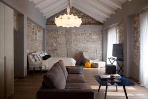 a living room with a couch and a bed at Hotel Osam - Adults Only in Supetar