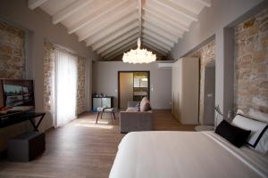 a bedroom with a bed and a living room at Hotel Osam - Adults Only in Supetar