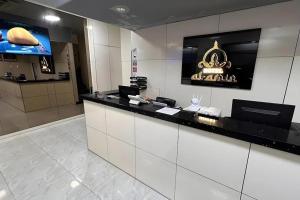 a hotel lobby with a counter with a phone at Hotel AL Amin in Kuala Lumpur