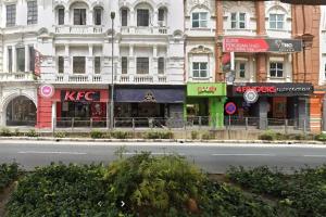 a city street with several shops on the side of a building at Hotel AL Amin in Kuala Lumpur