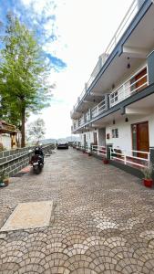 a building with a motorcycle parked in front of it at Vivens Villas in Ooty