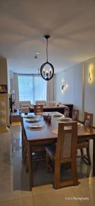 a dining room with a table and a couch at Chilax By The Ocean in Dehiwala