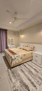a bedroom with a large bed and a rug at Chilax By The Ocean in Dehiwala
