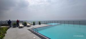 a swimming pool on the roof of a building at Chilax By The Ocean in Dehiwala