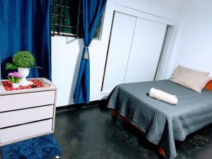 a bedroom with a bed and a dresser and a window at HOSPEDAJE don VICTOR in Chancayllo