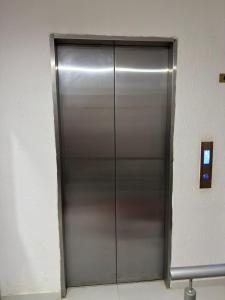 a large metal elevator door in a building at apartamento M&C in San Gil