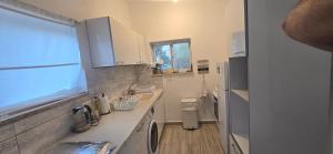 a small kitchen with a sink and a refrigerator at בית בכפר in Kefar Pines