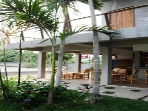 a house with two palm trees in front of it at K-1 Modern Art Hotel @ Nan in Nan