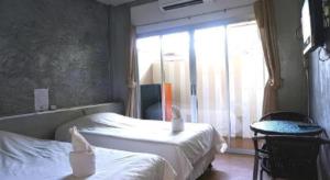 a hotel room with two beds and a window at K-1 Modern Art Hotel @ Nan in Nan