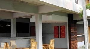 a group of chairs sitting outside of a house at K-1 Modern Art Hotel @ Nan in Nan