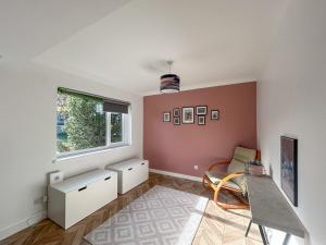 a living room with a table and a window at Hamble Haven in Lower Swanwick