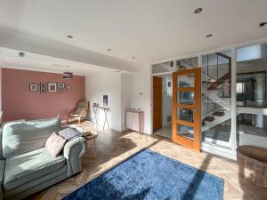 a living room with a couch and a staircase at Hamble Haven in Lower Swanwick