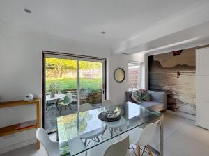 a living room with a glass table and chairs at Hamble Haven in Lower Swanwick