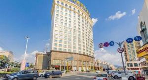 a large building with cars parked on a city street at Regency Hotel in Dongguan