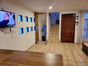 a room with a hallway with a television on a wall at Casa Ana Victoria in Morelia