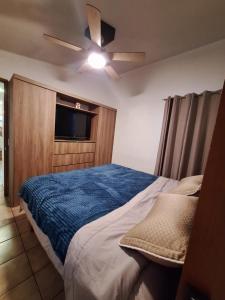 a bedroom with a bed with a ceiling fan at Casa Ana Victoria in Morelia