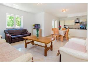 a living room with a couch and a table at Villa Dalmacija in Brištane