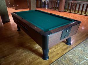 a pool table sitting on top of a wooden floor at Villa Dalmacija in Brištane