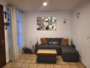a living room with a couch and a table at Casa Ana Victoria in Morelia