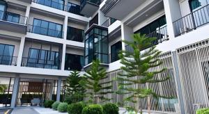 a building with two trees in front of it at @Sleep in Ban Rang Faet