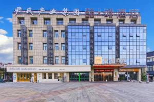 a large building with a lot of windows at James Joyce Coffetel Wuhu Wanzhi High-Speed Railway Station in Liangzhongchang