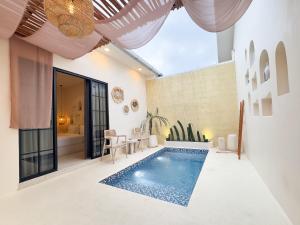 an indoor swimming pool in a house at Canggu Villas Family Yogyakarta in Ngaglik