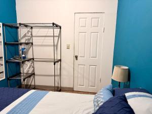a room with a bed and a white door at Apartamento - Casa Calderon, zona céntric in San Pedro Sula