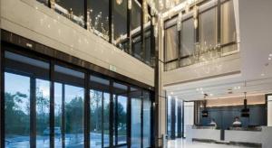 a building with large glass windows and people sitting on a bench at Echarm Hotel Changsha High-speed Railway Station in Changsha